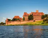 Zamek w Malborku, często uznawany za najlepsze muzeum w Polsce, majestatycznie wznosi się nad rzeką Nogat.