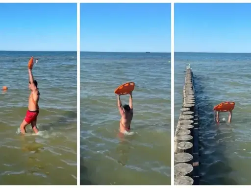 Ratownik z kołem ratunkowym przy falochronach nad morzem. Słońce, woda i bezpieczeństwo plażowiczów.