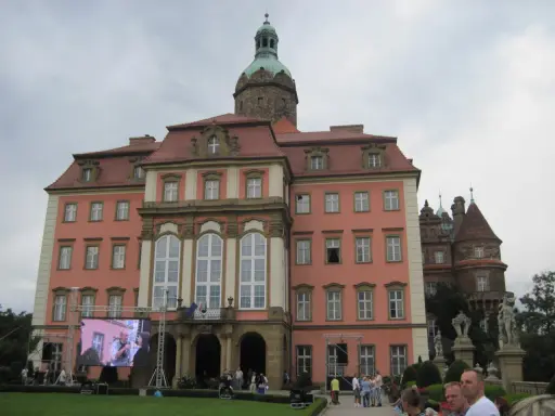 Zamek Książ z wieżą i ekranem LED przed fasadą, na którym wyświetlany jest obraz.